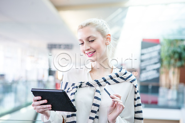 30대 서양인 성인 성인여자한명만 여자 한명 JPG 아웃포커스 앞모습 포토 결제 들기 모바일 모바일쇼핑 상반신 쇼핑 쇼핑몰 신용카드 실내 웃음 태블릿