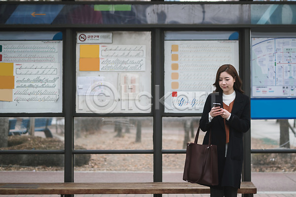 30대 성인 성인여자한명만 여자 한국인 한명 JPG 앞모습 포토 기다림 대중교통 들기 버스정류장 비즈니스우먼 상반신 서기 스마트폰 야외 워킹맘 응시 주간 출근 퇴근 핸드백