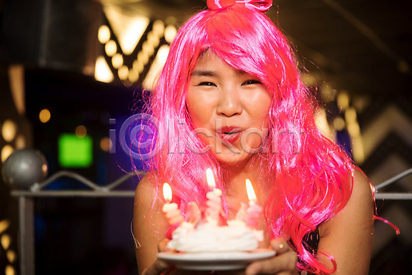 즐거움 축하 20대 동양인 사람 성인 성인여자한명만 신체부위 여자 한명 JPG 앞모습 포토 가발 미소(표정) 바람불기 상반신 생일 생일축하 실내 얼굴 응시 조명 촛불 케이크 클럽 파티