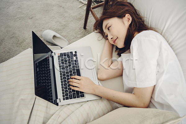 휴식 20대 사람 성인 성인여자한명만 여자 한국인 한명 JPG 옆모습 포토 하이앵글 공휴일 노트북 눕기 미소(표정) 베개 상반신 소확행 실내 싱글 싱글라이프 아침 안식처 우먼라이프 웹서핑 응시 이불 침대