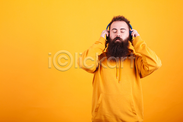 남자 성인 성인남자한명만 한명 JPG 앞모습 포토 해외이미지 노란색 눈감음 상반신 실내 음악감상 헤드셋