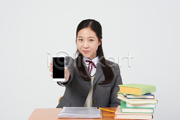 10대 십대여자한명만 여자 중학생 청소년 한국인 한명 JPG 앞모습 포토 교복 미소(표정) 보여주기 상반신 스마트폰 스튜디오촬영 실내 십대라이프스타일 앉기 여중생 여학생 연필 의자 자랑 책 책더미 책상 흰배경