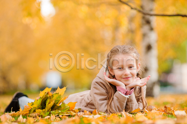 귀여움 소녀(어린이) 소녀한명만 어린이 여자 한명 JPG 아웃포커스 앞모습 포토 해외이미지 가을(계절) 공원 꽃받침 낙엽 노란색 단풍 엎드리기 전신