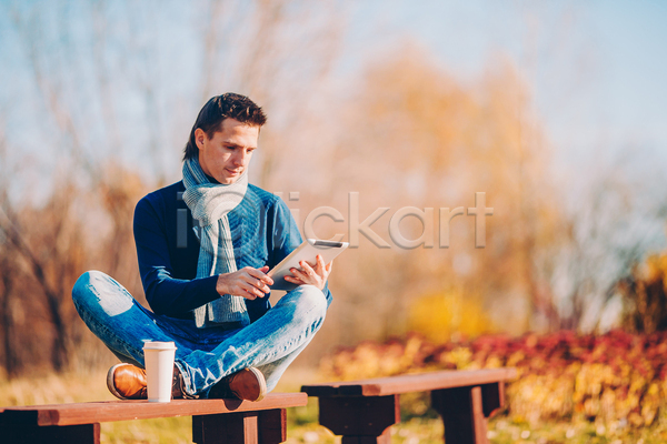 남자 성인 성인남자한명만 한명 JPG 포토 해외이미지 가을(계절) 가을풍경 공원 미소(표정) 숲 앉기 야외 응시 잡기 커피 컵 태블릿