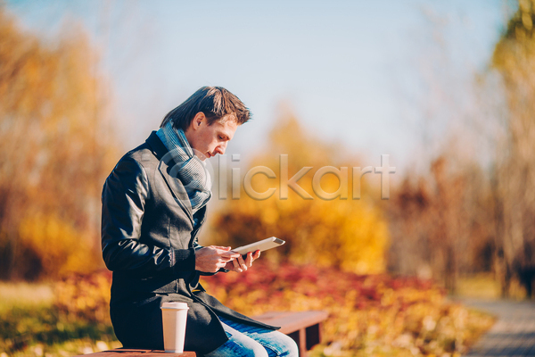 남자 성인 성인남자한명만 한명 JPG 포토 해외이미지 가을(계절) 가을풍경 공원 미소(표정) 숲 앉기 야외 응시 잡기 커피 컵 핸드폰