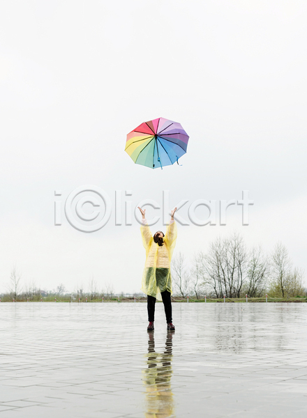 성인 성인여자한명만 여자 한명 JPG 앞모습 포토 해외이미지 던지기 만세 반사 비(날씨) 서기 야외 우비 우산 전신 주간 하늘