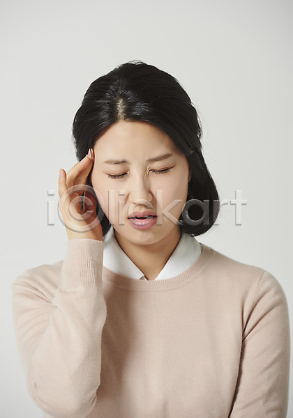 고통 스트레스 30대 성인 성인여자한명만 여자 한국인 한명 JPG 근접촬영 앞모습 포토 감정 두통 상반신 스튜디오촬영 실내 앉기 찡그림 표정 표현 회색배경
