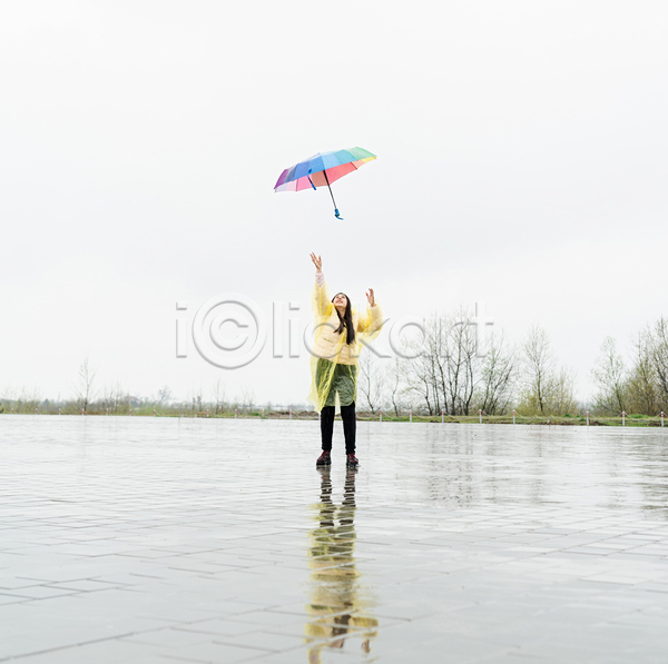 성인 성인여자한명만 여자 한명 JPG 앞모습 포토 해외이미지 던지기 반사 비(날씨) 서기 야외 올려보기 우비 우산 전신 주간 하늘