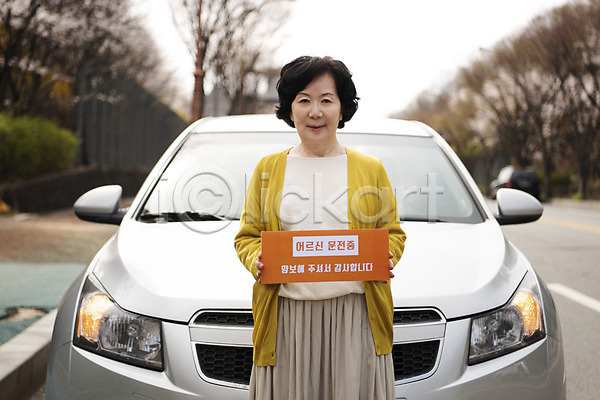 사회이슈 60대 노년 노인여자한명만 여자 한국인 한명 JPG 앞모습 포토 광고판 도로 들기 미소(표정) 배너 배려 사각프레임 사고예방 상반신 알림 야외 양보 양보운전 자동차 자동차보험 주간 할머니