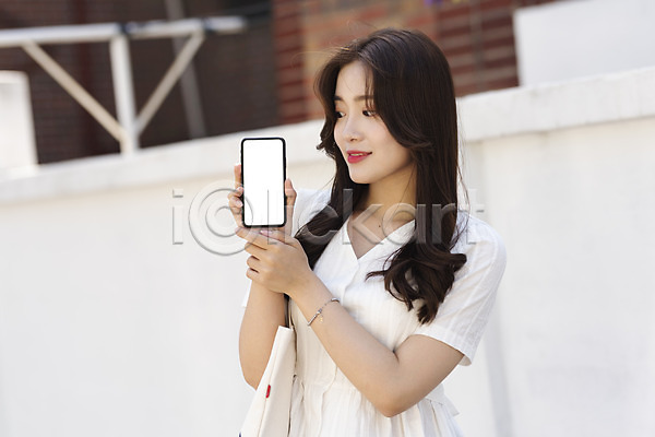 스마트 즐거움 20대 성인 성인여자한명만 여자 한국인 한명 JPG 앞모습 포토 거리 들기 보여주기 상반신 서기 스마트폰 싱글라이프 야외 에코백 여름(계절) 우먼라이프 응시 인싸 주간 캐주얼