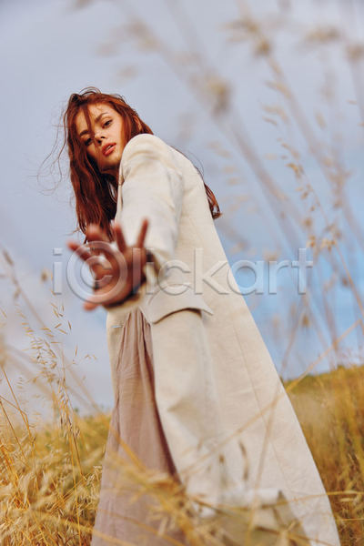 성인 성인여자한명만 여자 한명 JPG 로우앵글 옆모습 포토 해외이미지 가을(계절) 내추럴 밭 손내밀기 야외 자연 전신 주간 코트 하늘