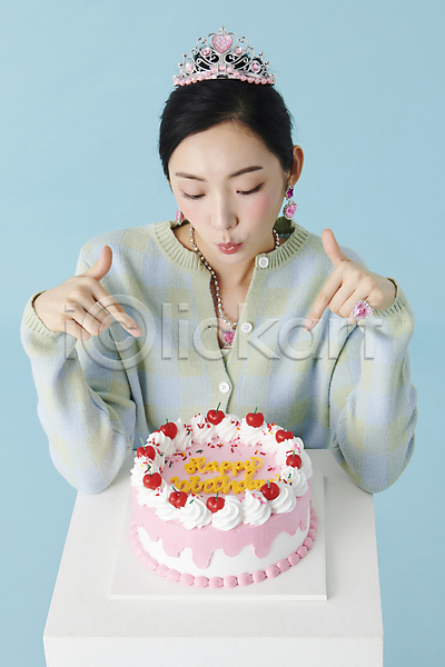 20대 성인 성인여자한명만 여자 한국인 한명 JPG 앞모습 포토 가리킴 공주(공주님) 공주님 상반신 생일 생일축하 생일케이크 생일파티 스튜디오촬영 실내 왕관 응시 장신구 파란배경