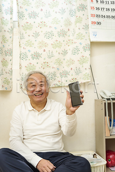 기쁨 70대 남자 노년 노인남자한명만 한국인 한명 JPG 앞모습 포토 독거노인 들기 미소(표정) 보여주기 상반신 스마트폰 실내 실버라이프 앉기 응시 할아버지