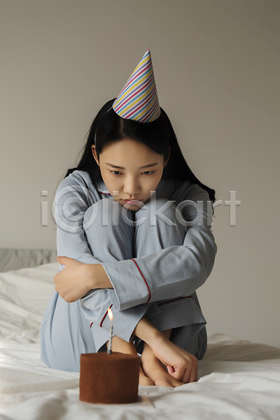 슬픔 20대 성인 성인여자한명만 여자 한국인 한명 JPG 앞모습 포토 고깔(모자) 생일 실내 싱글라이프 앉기 우먼라이프 우울증 웅크림 응시 잠옷 전신 주간 초콜릿케이크 촛불 침대 코로나바이러스 코로나블루