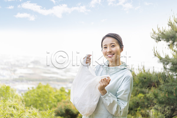 20대 성인 성인여자한명만 여자 한국인 한명 JPG 아웃포커스 앞모습 포토 그린캠페인 들기 미소(표정) 비닐봉투 산 상반신 쓰레기 쓰레기줍기 야외 우먼라이프 응시 자연보호 주간 친환경 플로깅 하늘