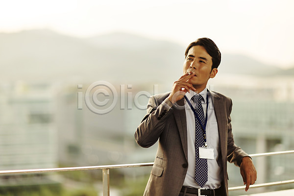 고독 고민 휴식 30대 남자 성인 한국인 한명 JPG 앞모습 포토 기댐 난간 담배 도시 발코니 비즈니스맨 사원증 상반신 야외 정장 주간 흡연
