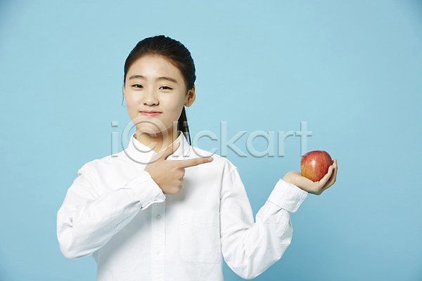 십대여자한명만 여자 중학생 청소년 한국인 한명 JPG 앞모습 포토 가리킴 들기 사과(과일) 상반신 스튜디오촬영 실내 여중생 여학생 와이셔츠 파란배경