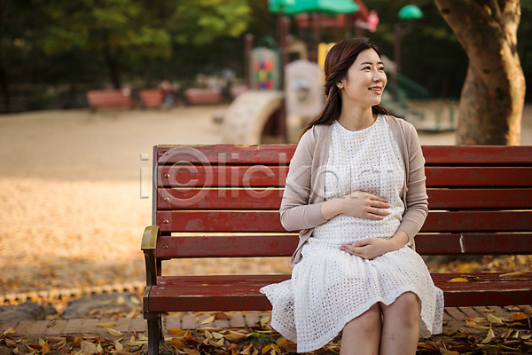 산책 30대 성인 성인여자한명만 여자 한국인 한명 JPG 앞모습 포토 공원 놀이터 벤치 상반신 쓰다듬기 앉기 야외 웃음 응시 임산부 임신 주간 태교